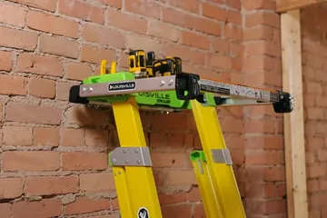 Louisville Ladder parts and accessories laid out on a workbench