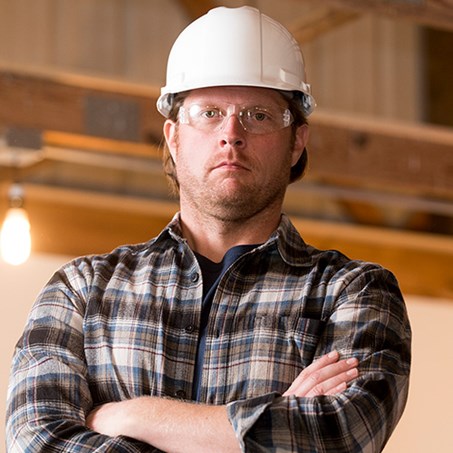 Image of a construction worker with arms crossed