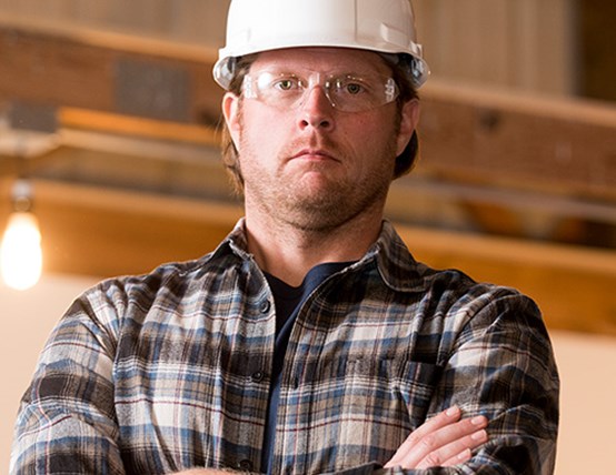 Image of a construction worker with arms crossed